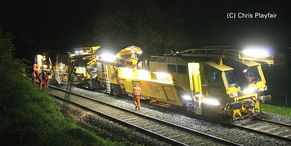 Overview of the ballast cleaner at work. The old stone & spoil can be seen being discharged out of the conveyor belt onto the DOWN Cess. 230513