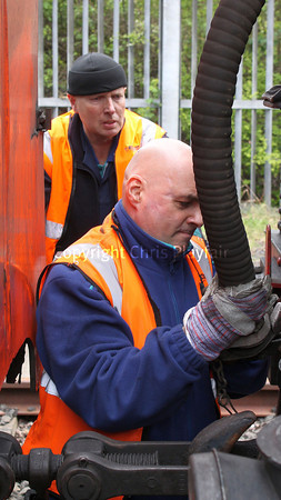 The RPSI have recently taken on 2 more steam drivers for mainline operation. Under the watchful eye of long-term train driver Noel Playfair , Barney McReynolds connects the vacuum bag on 186 back onto the locomotive before running round to return to Whitehead. 090412