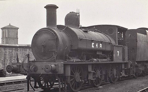 EAST KENT LIGHT RAILWAY - No.7 - Beattie LSWR 0-6-0ST - built 1882 by Beyer Peacock & Co. as LSWR No.127 - 01/26 sold to EKR - 1936 new smokebox fitted in place of original sloping front type - 09/44 withdrawn - 03/46 scrapped at Ashford, where seen. The East Kent Light Railway was part of the Colonel Stephens group of cheaply built rural light railways in England. Holman Fred Stephens was engineer from its inception, subsequently becoming director and manager. The line ran from Shepherdswell to Wingham (Canterbury Road) Station with a branch from Eastry through Poison Cross to Richborough Port. Built primarily to serve colliery traffic, the line was built with many spurs and branches to serve the mostly unsuccessful mines of the Kent coalfield, with cancelled plans to construct several others. The success of Tilmanstone colliery allowed the main line of the railway to continue operation until 1986, when the remainder of the line became a heritage railway.