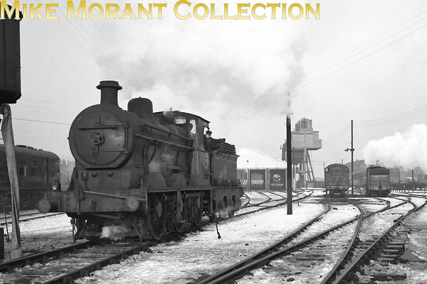 Vintage Irish Railways - Northern Ireland - UTAReboilered Heavy Goods 'V1' class 0-6-0 No. 13 was a Derby product dating from 1923. I'm assuming that this is a snow covered York Road, Belfast shed shot. Note the glimpse of the recently restored U2 4-4-0 No. 74 in the background which, together with Joe Cassells' observation that the shed is in the process of being converted into a diesel depot, should help in the pinpointing of a date which must, in any case, be the late 1950's.From an original Bob O'Sullivan negative.
[Mike Morant collection]