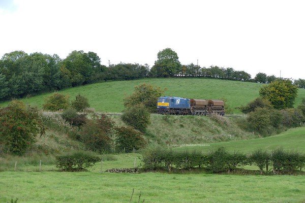 18.9.18. NIR GM 112 on a ballast hopper transfer from Ballymena Permanent Way Depot to York Road Depot Belfast. the train is seen here approaching Slaght level crossing