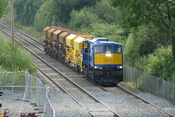 23.7.19. GM 8113  passes Silverwood hauling the NIR Ballast Train from Belfast to Poyntzpass for loading.